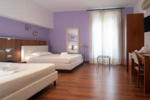 Łóżko lub łóżka w pokoju w obiekcie Hotel Tonic