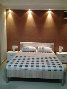 a bedroom with a bed with two pillows on it at Ljuta Studios in Kotor
