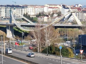 a bridge over a highway with cars on the road at Piso termal in Ourense