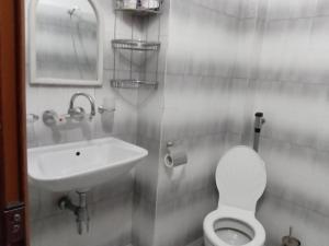 a bathroom with a toilet and a sink at Къща за гости Петрови in Primorsko