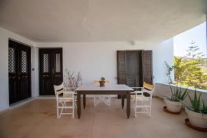 a dining room with a table and chairs at Lotos Beach Home in Kini