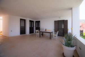 a dining room with a table and chairs in a house at Lotos Beach Home in Kini +28 photos
