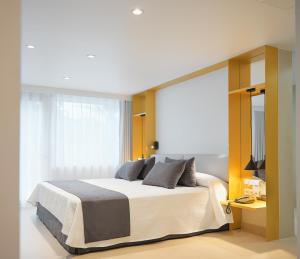 a bedroom with a bed and a large window at Catedral Almería in Almería