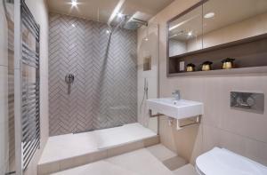 a bathroom with a shower and a sink and a toilet at Hudson Quarter Luxury Apartments in York +13 photos