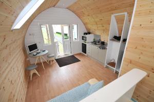 an overhead view of a room with a desk and a kitchen at Glastonbury Glamping in Wells