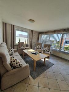 a living room with a couch and a coffee table at Apartmenthaus Robbe Luv in Neuharlingersiel