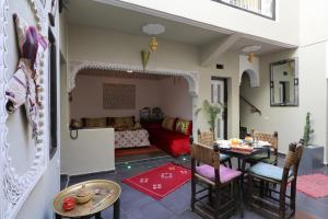 a living room with a couch and a table at Riad Diamant La Ville Rouge in Marrakesh