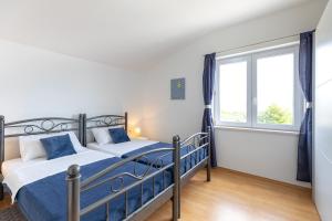 Postel nebo postele na pokoji v ubytování Apartments Villa Maja