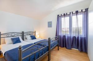 Postel nebo postele na pokoji v ubytování Apartments Villa Maja