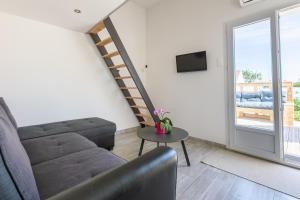 a living room with a couch and a table at Cosy Corner in Saint-Xandre