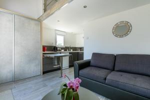 a living room with a couch and a table at Cosy Corner in Saint-Xandre