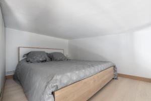 a bed with two pillows on it in a room at Cosy Corner in Saint-Xandre