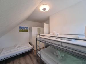 a room with three bunk beds in it at Ferienwohnung Nordwind in Neßmersiel