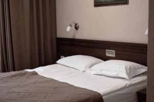 Кровать или кровати в номере Гостиница Виктория