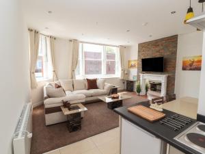 a living room with a couch and a fireplace at Flat 2 in Prestatyn