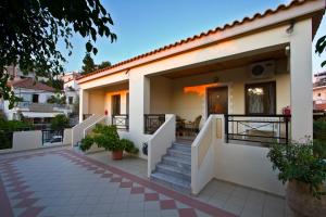 a house with a staircase leading to the front door at SHINE VERANDA PRIVE APTS 7PERSONS in Plataniás