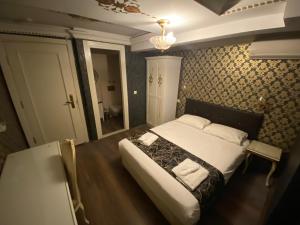 a hotel room with a bed and a television at Alyon Hotel Taksim in Istanbul