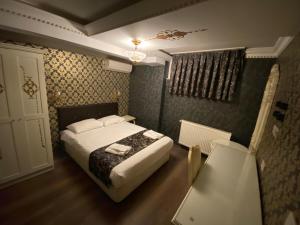 a bedroom with a white bed and white walls at Alyon Hotel Taksim in Istanbul