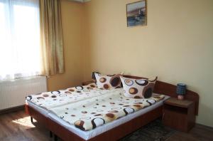 a bedroom with a large bed with polka dot pillows at Villa AS in Świnoujście