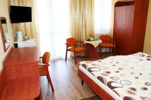 a bedroom with a bed and a table and chairs at Villa AS in Świnoujście +5 photos
