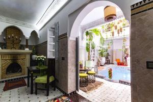 a living room with a swimming pool and a fireplace at Riad Eloise in Marrakesh