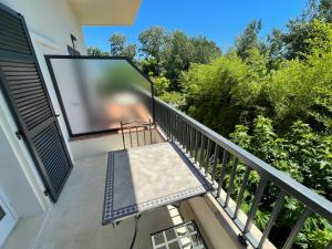 a balcony with a large screen tv on a building at Villa Louise-Rose in Villeneuve-Loubet