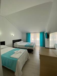 Ліжко або ліжка в номері Nefis Hotel Ölüdeniz