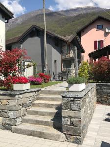 uma casa com um conjunto de degraus de pedra em frente em B&B Cà Nosa em Gordevio