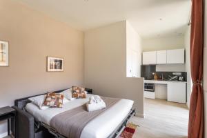 Cet appartement comprend une chambre avec un lit et une cuisine. dans l'établissement LA COUR DES CARMÉLITES 2 - Studio calme en centre-ville, à Rennes