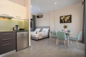 a kitchen and living room with a table and a couch at La Casa De Zante in Laganas