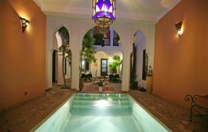 a large room with a swimming pool in a house at Riad Alwane in Marrakesh