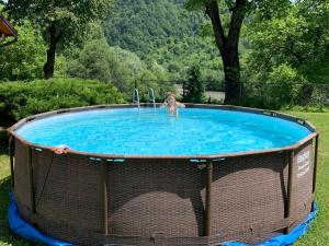 a young girl is in a swimming pool at Nad Cheremoshem in Tyudov