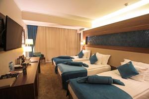 Postel nebo postele na pokoji v ubytování Paşapark Selçuklu Hotel
