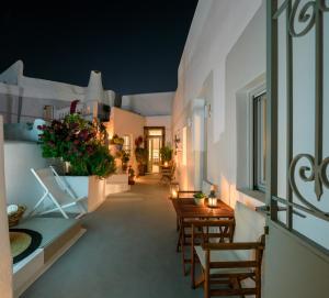 a hallway with a table and chairs in a house at Betty's Home Santorini in Karterados