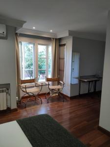 a living room with two chairs and a table at Villa Antumalal B&B in Málaga