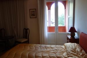 A bed or beds in a room at Hotel Roma