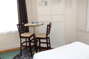 Postel nebo postele na pokoji v ubytování Hotel du Gambrinus