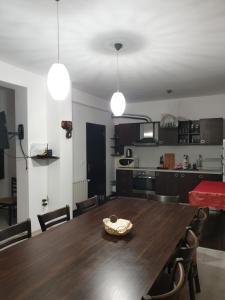 Il comprend une cuisine et une salle à manger avec une table et des chaises en bois. dans l'établissement Бадевски рай- къща София, à Veliko Tarnovo