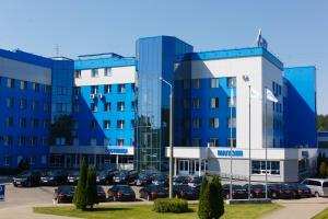 a large blue building with cars parked in a parking lot at Гостиница Газпром трансгаз Беларусь in Minsk