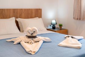 a bed with towels and towels on it with a bed at Blue View Villa #3 Luxury Sea View Private Jacuzzi in Parasporos +22 photos