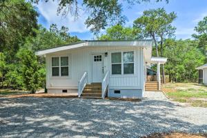 a small white house with a driveway at Modern Oak Island Escape 1 Mile to Long Beach! in Oak Island