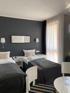 Postel nebo postele na pokoji v ubytování HOTEL Amber Suite & SPA - Enklawa dla Dorosłych