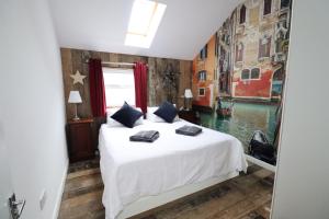 a bedroom with a bed with a view of a canal at 28 Marsh Road in Gurnard