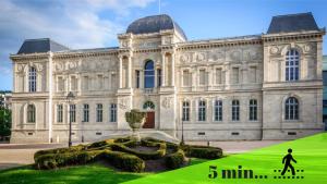 a large building with a man walking in front of it at Love Room - Suite romantique avec spa privatif in Le Puy en Velay