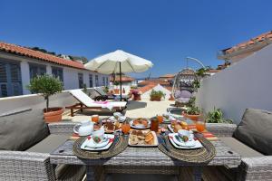 a table with food on it on a patio at Agate Hydra luxury apartment in Hydra
