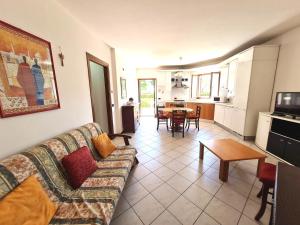 a living room with a couch and a table at Apartments Gli Ulivi in Lazise