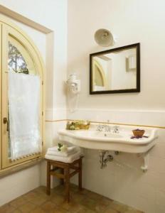 a bathroom with a sink and a mirror at La Locanda del Borgo in Pietralunga
