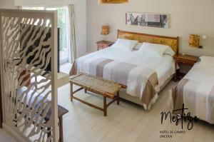 a bedroom with a bed and a chair and a window at Mestizo Hotel in Lincoln