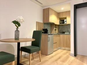 a kitchen with a table and green chairs in a room at Ribeira House in Mirandela +60 photos
