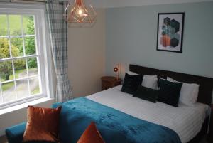 a bedroom with a bed and a window at Penygelli Apartments in Newtown
